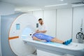 Healthcare professional is preparing patient for brain MRI scan
