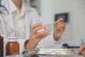 Healthcare service and pharmacy worker with customer at store counter for medication explanation. Pharmaceutical advice and Royalty Free Stock Photo