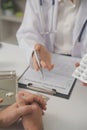 Healthcare service and pharmacy worker with customer at store counter for medication explanation. Pharmaceutical advice and Royalty Free Stock Photo