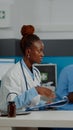 Healthcare specialist discussing with old patient at desk