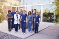 Healthcare team with ID badges stand outdoors, full length Royalty Free Stock Photo