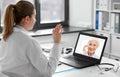 doctor with laptop having video call with patient Royalty Free Stock Photo