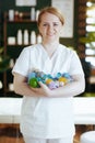 happy massage therapist woman in massage cabinet