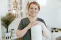 Portrait of happy massage therapist woman in massage cabinet