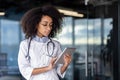 Healthcare woman doctor specialist with a digital tablet provides expert advice and care to patient. Using technology Royalty Free Stock Photo