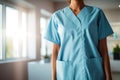 Healthcare Worker in Blue Scrubs Standing by a Bright Window
