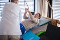 A healthcare worker helping paralysed senior patient in hospital. Royalty Free Stock Photo