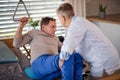 A healthcare worker helping paralysed senior patient in hospital. Royalty Free Stock Photo