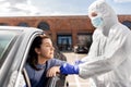 Healthcare worker making coronavirus test at car Royalty Free Stock Photo