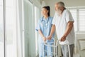 Healthcare worker with man using walking support Royalty Free Stock Photo