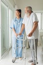 Healthcare worker with man using walking support Royalty Free Stock Photo