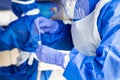 Healthcare worker mixing covid swab taken from patient into culture in extraction kit