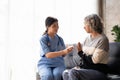 Healthcare worker or nurse caregiver giving pills, showing a prescription drug to senior woman. Elderly healthcare Royalty Free Stock Photo