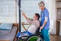 A healthcare worker and senior patient in wheelchair, physiotherapy. Royalty Free Stock Photo