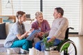 A healthcare worker visiting senior patient in wheelchair at home.