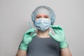 Healthcare worker woman in professional uniform holding syringe and ampoule. Medicine and vaccination concept