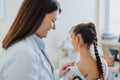 Experienced Female Doctor Performing Thorough Medical Examination Using Otoscope.