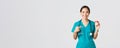 Healthcare workers, preventing virus, quarantine campaign concept. Smiling pretty asian female physician, nurse in Royalty Free Stock Photo