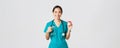 Healthcare workers, preventing virus, quarantine campaign concept. Smiling pretty asian female physician, nurse in Royalty Free Stock Photo