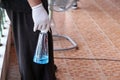 Healthcare workers wear rubber gloves and carry plastic bottles with alcohol gel to clean covid-19 disinfection.