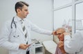 Doctor washing and cleaning elderly patients ears. Washing ears concept.