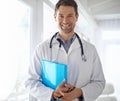 Healthcare you can trust. Portrait of a handsome male doctor standing with his arms folded. Royalty Free Stock Photo