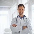 Healthcare you can trust. Portrait of a handsome male doctor standing with his arms folded. Royalty Free Stock Photo
