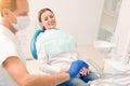 Cheerful woman with braces attending dental professional