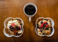 Healthy Acai berry bowls with fruit and granola and black coffee