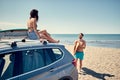 Healthy Active Lifestyle. Surfing. Summer Vacation. Extreme Sport. surfer girl sitting on the car and getting ready for surfing. Royalty Free Stock Photo