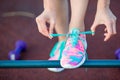 Healthy active lifestyle woman athlete tying running shoes. Sporty girl getting ready for jogging workout. Closeup of Royalty Free Stock Photo