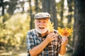 Healthy active senior man holding a. Portrait of a senior autumn man outdoors. Elderly man smiling outdoors in nature Royalty Free Stock Photo