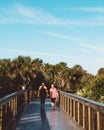 Two active women walk the boardwalk in New Smyrna Beach, Florida Royalty Free Stock Photo