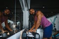 healthy african man working out with dumbbells in gym. Royalty Free Stock Photo