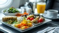 Healthy airplane meal with fresh ingredients served on a tray table, emphasizing nutritious in-flight dining options Royalty Free Stock Photo