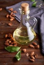 Healthy Almond oil in glass bottles. Dark wooden background Copy space