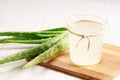 Aloe vera juice in a glass on wooden paddle board Royalty Free Stock Photo