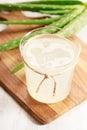 Aloe vera juice in a glass on wooden paddle board Royalty Free Stock Photo