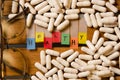 Healthy alphabet and capsule drug with glasses on wood background Royalty Free Stock Photo