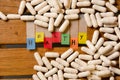 Healthy alphabet and capsule drug on wood background Royalty Free Stock Photo