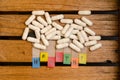 Healthy alphabet and capsule drug on wood background
