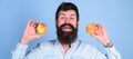 Healthy alternative. Man bearded smiling holds apples in hands blue background. Healthcare dieting vitamin nutrition
