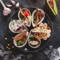 Healthy appetizer or snack with hummus, cod liver with ricotta, guacamole, rabbit sirloin, eggplant caviar in bowls over grey back