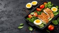 Healthy and appetizing meal prep container with grilled chicken, salad, and boiled egg.