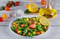 Healthy arugula salad with strawberries, pineapple and pistachios, sesame seeds, oil and lemon Royalty Free Stock Photo