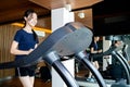 Healthy asian child girl exercise using jogging track for health,people walking on a treadmill to warm up before running on