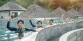 Healthy Asian elderly, aging senior old friends exercising in swimming pool having fun, enjoying summer vacation Royalty Free Stock Photo