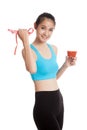 Healthy Asian girl diet with tomato juice and measuring tape on Royalty Free Stock Photo