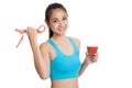 Healthy Asian girl diet with tomato juice and measuring tape on Royalty Free Stock Photo