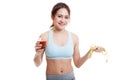 Healthy Asian girl diet with tomato juice and measuring tape on Royalty Free Stock Photo